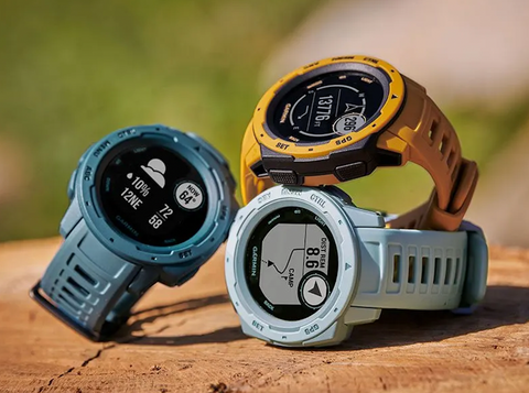 Three Garmin watches in three different colors